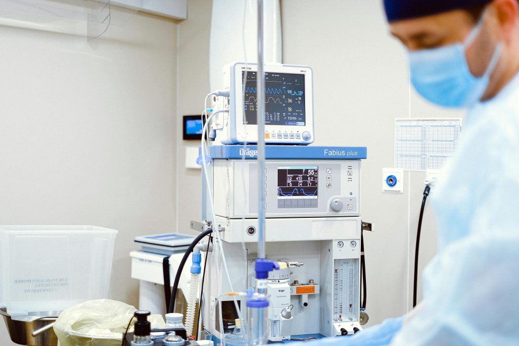 A Medical Professional Wearing Face Mask while Standing Near Operating Room